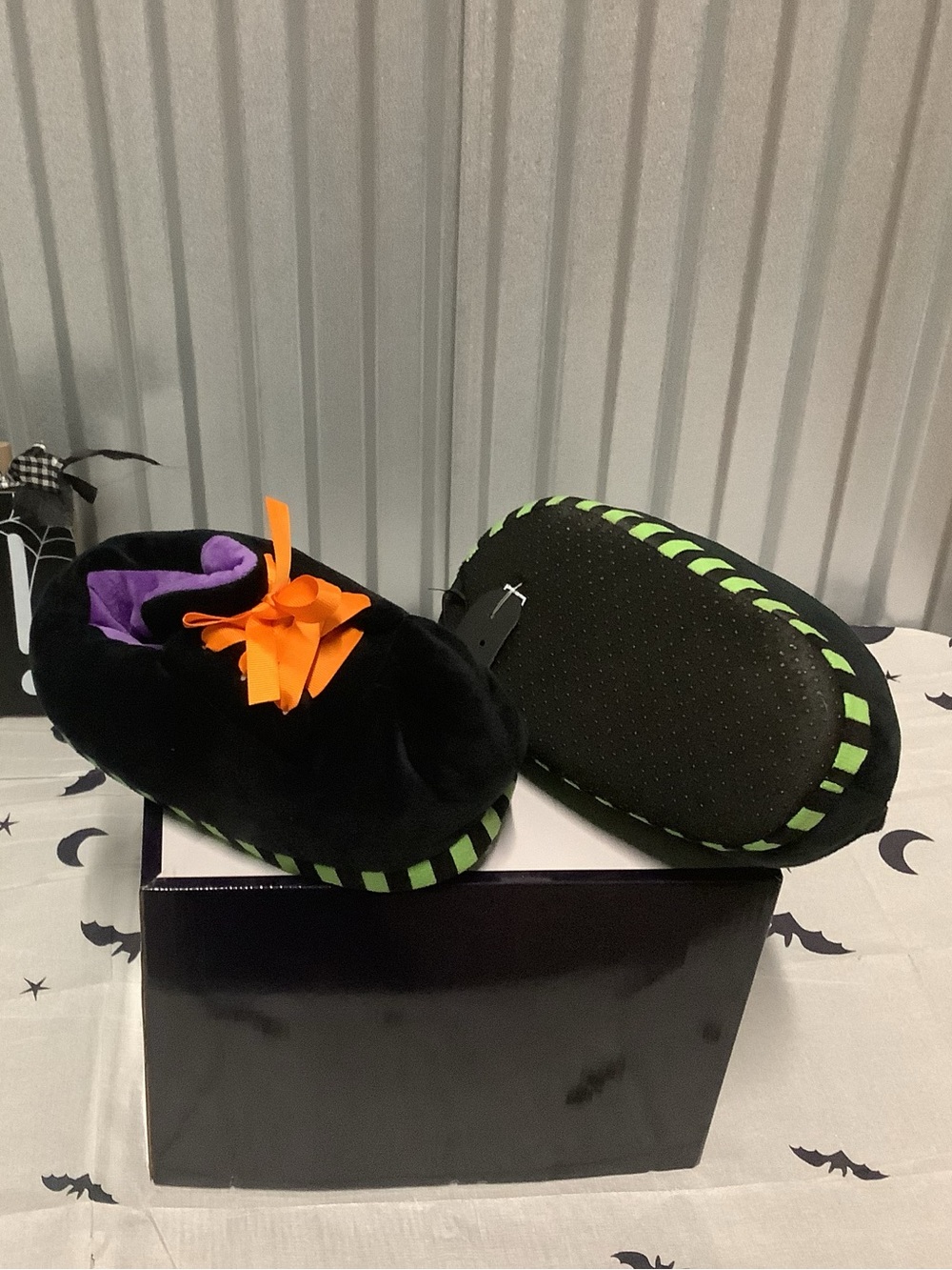 Adult men’s/women’s Black Plush Slip-On Slippers with Green Trim and Orange Bow